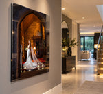 Acrylic wall print of a bride in a candlelit castle doorway, hanging in a bright hallway