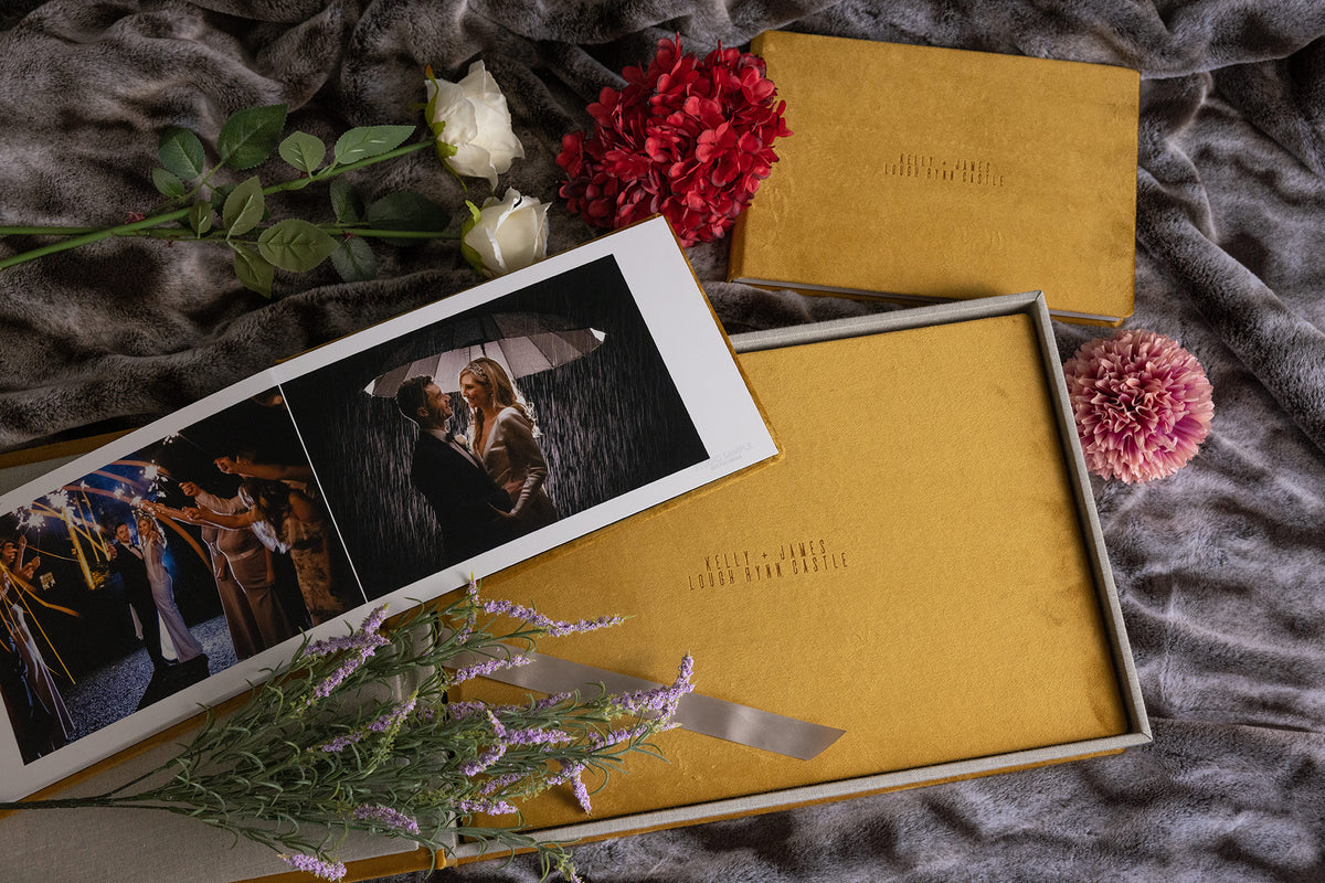 Dijon Yellow velvet wedding album and matching parent album with engraved covers, styled with roses and lavender