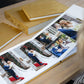 Woman looking through an open Dijon Yellow velvet wedding album, with matching parent albums and album box on the table