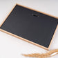 Back of a natural oak photo frame showing the hanger, ready to hang