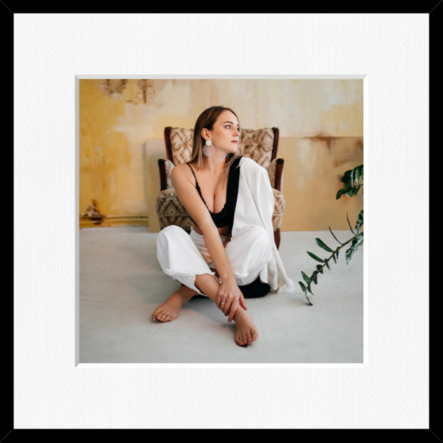 Square framed photo print in a black frame with a white mount