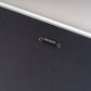 Back of a white photo frame showing the sawtooth hanger, ready to hang