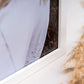 Close-up of the corner of a white photo frame