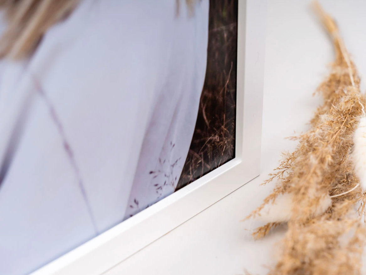 Close-up of the corner of a white photo frame