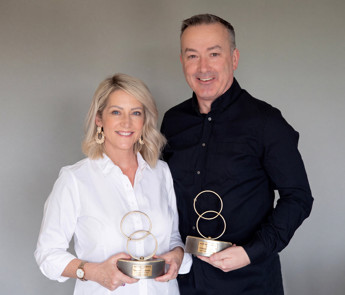 Gary and Jill Barrett, owners of weddingalbums.ie, holding their Best Wedding Album Service awards