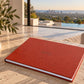 Red leatherette landscape wedding album with cover engraving on a stone table with a sea view