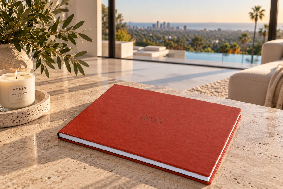 Red leatherette landscape wedding album with cover engraving on a stone table with a sea view