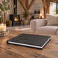 Raven Black leatherette landscape wedding album on a rustic wooden coffee table by the fire