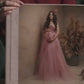 Acrylic photo cover album held in hand, with a full-page acrylic front showing a maternity portrait and a Soft Rose Pink velvet spine