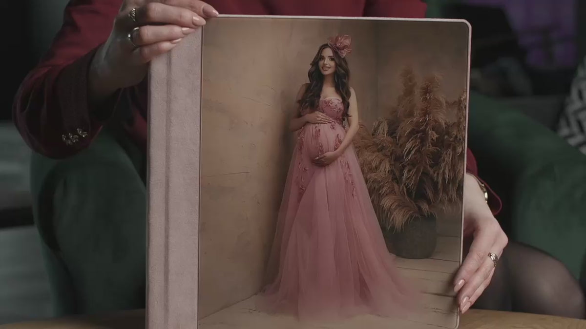 Acrylic photo cover album held in hand, with a full-page acrylic front showing a maternity portrait and a Soft Rose Pink velvet spine