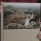 Acrylic photo cover wedding album held in hand, with a half-page acrylic panel showing the couple's wedding photo on a Cappuccino linen cover