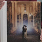 Acrylic photo cover wedding album held in hand, with a full-page acrylic front showing the couple's wedding photo and a Frothy White vegan leatherette spine